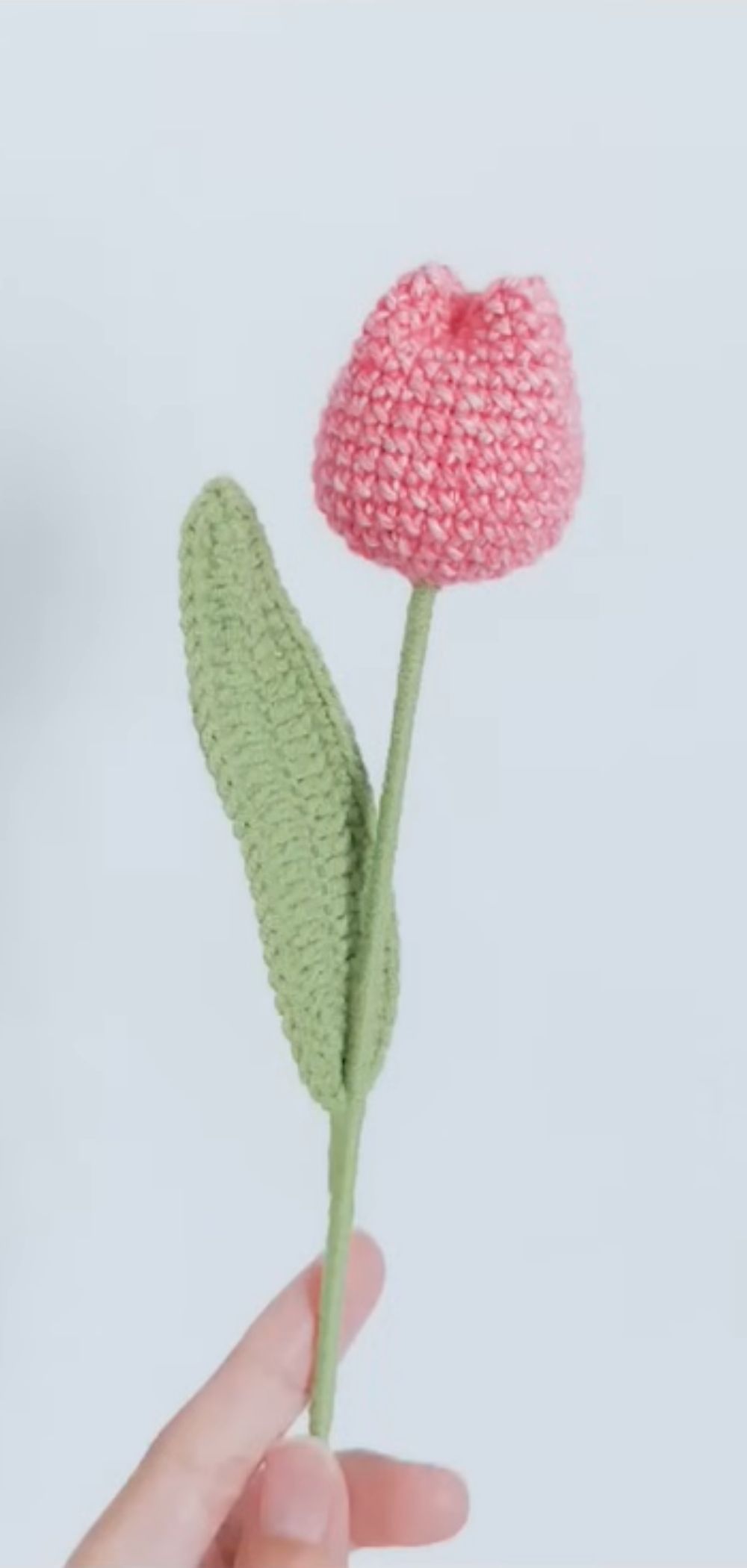 Handcrafted crochet tulip flowers in vibrant colors against a white background.